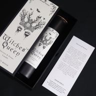 Witches’ Queen ritual spell card beside the candle
